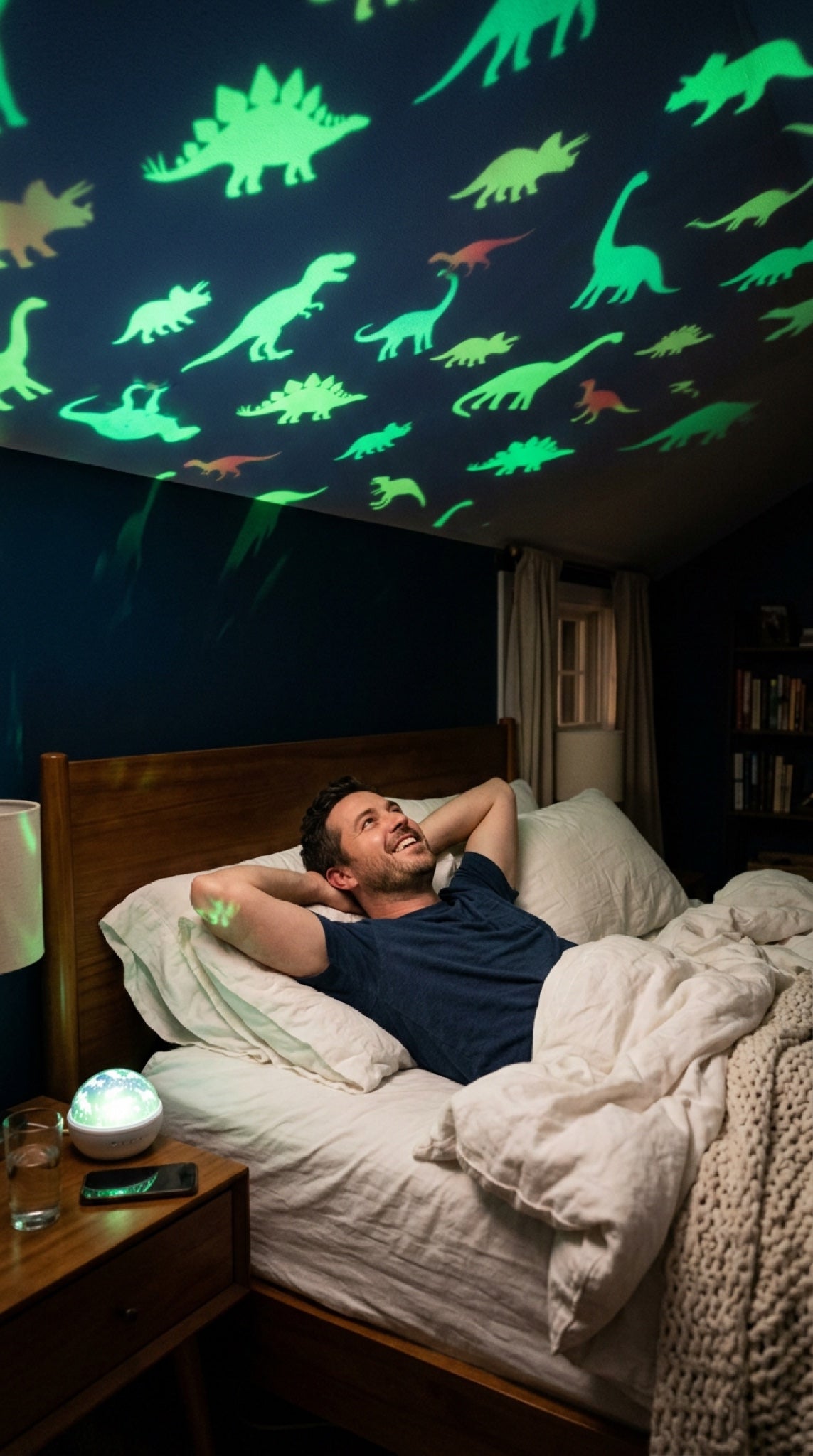 Grown-up dino fan smiling at the dinosaur projection on his bedroom ceiling